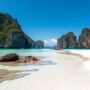 Pristine beach in the Philippines with clear turquoise water and limestone cliffs, highlighting what sustainable travel aims to preserve