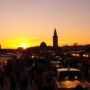 Sunset over Jemaa el-Fnaa square in Marrakech with food stalls and bustling crowds during eco-tourism in Morocco